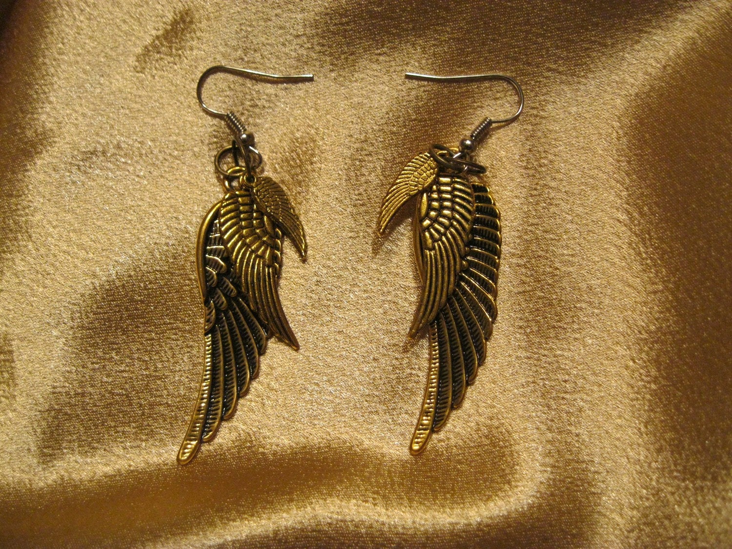 Golden triple wing steampunk avian aviator earrings