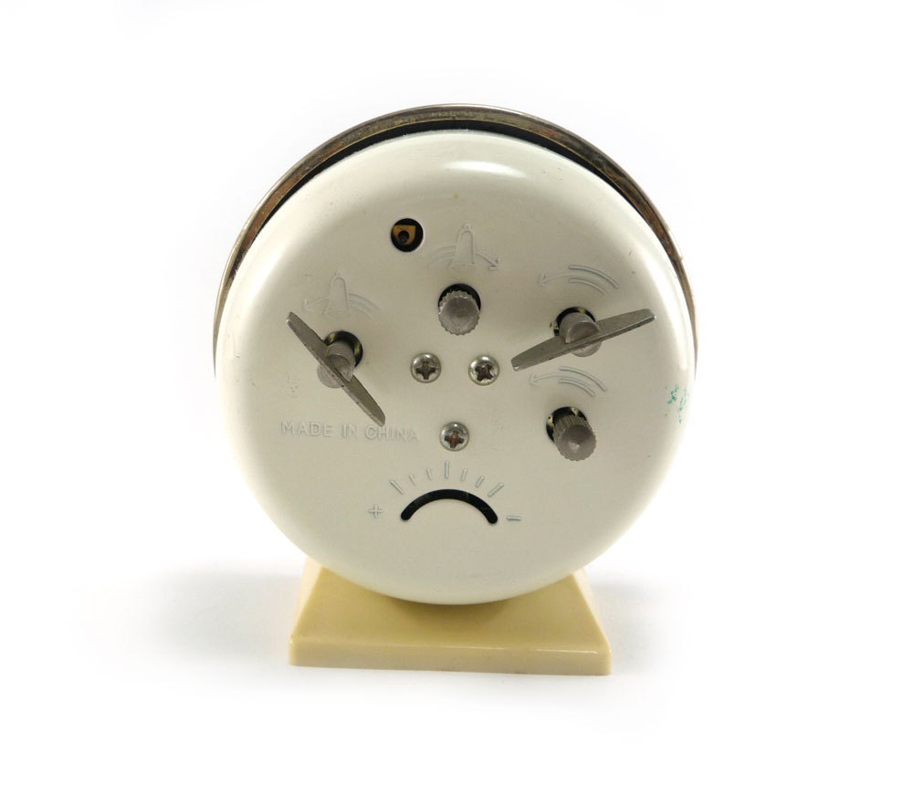 Vintage alarm clock, gold white black with luminous hands