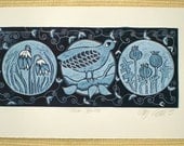 linocut, with bird and flowers in folk art blue, snow drops and poppy seeds in circles
