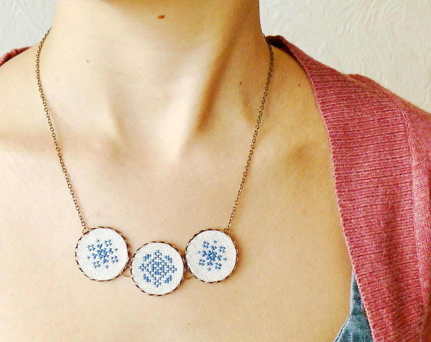 Cross stitch necklace with three navy blue ornament in bronze