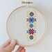 Ukrainian ornament hand embroidery cross stitch in wooden hoop