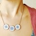Cross stitch necklace with three navy blue ornament in bronze