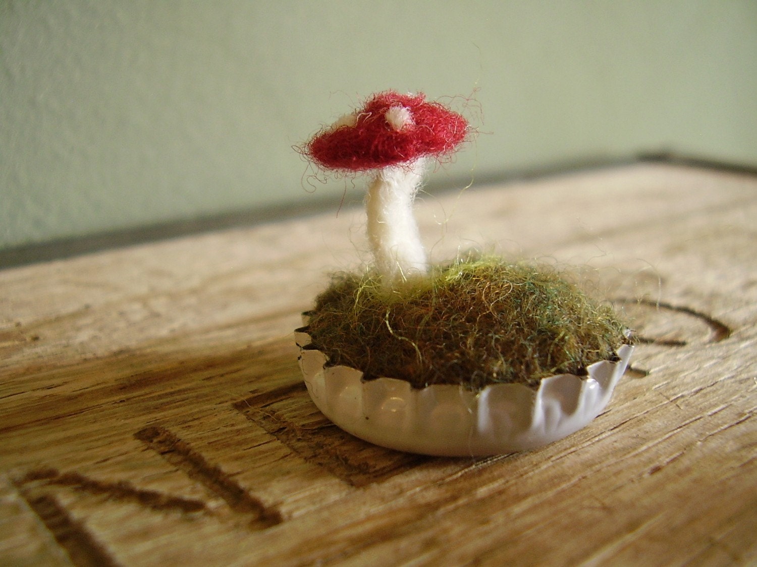 Felted red amanita mushroom in a white bottlecap