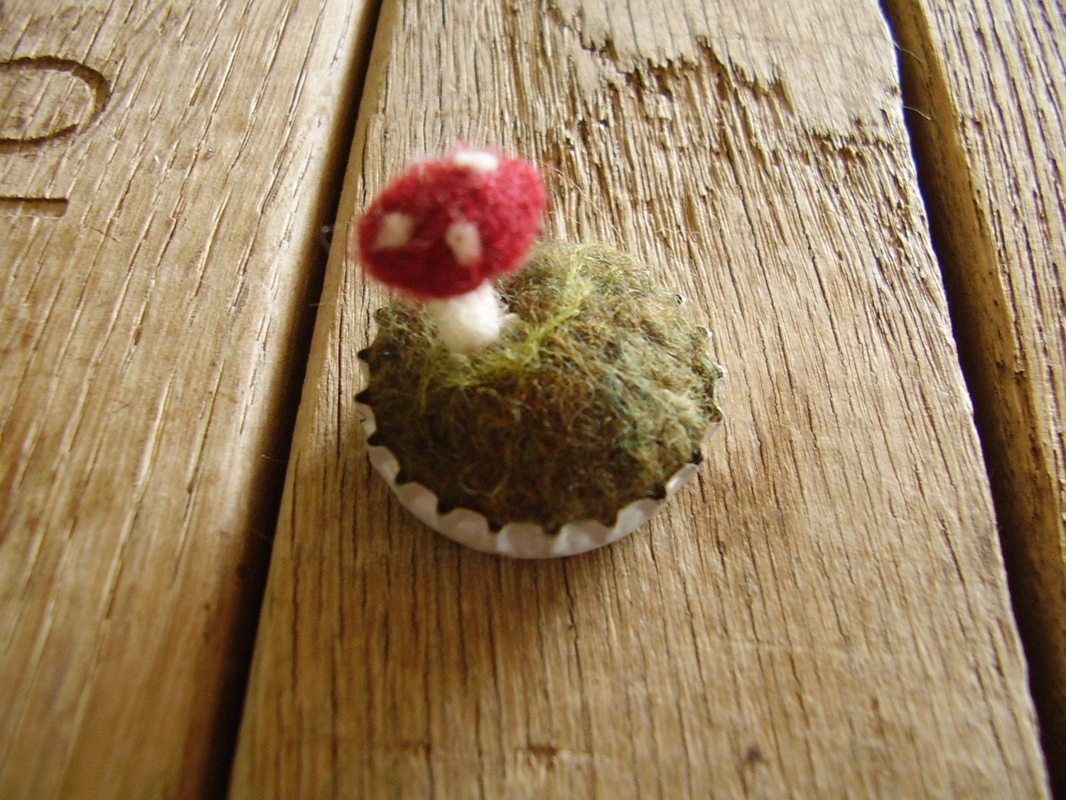 Felted red amanita mushroom in a white bottlecap