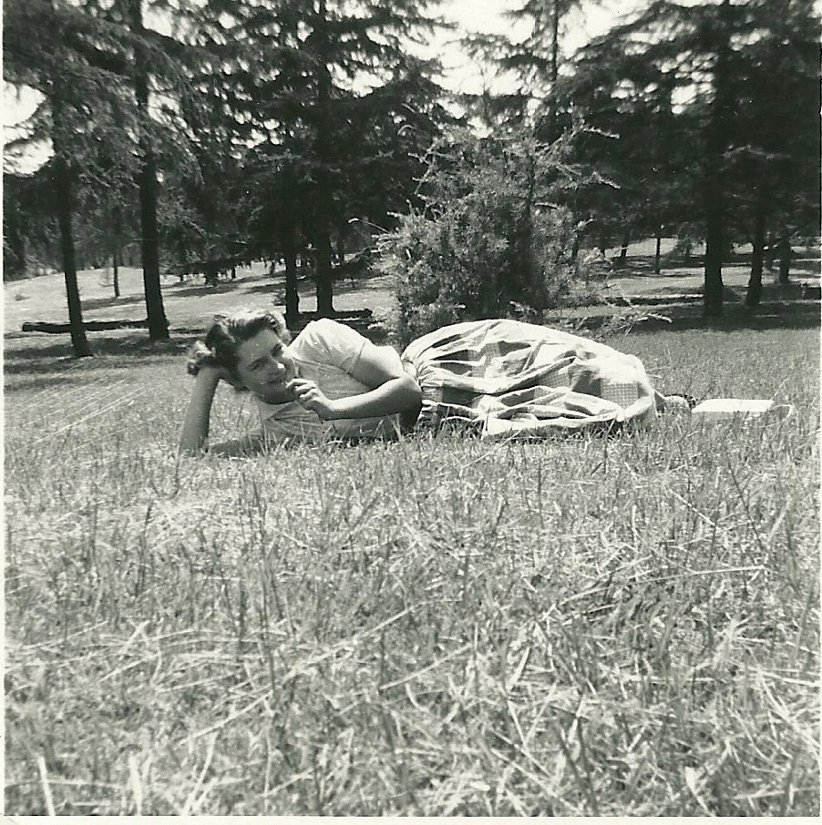 1950s woman lying in grass