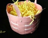 paper basket handmade out of woven cardstock in pastel pink with ribbon handles