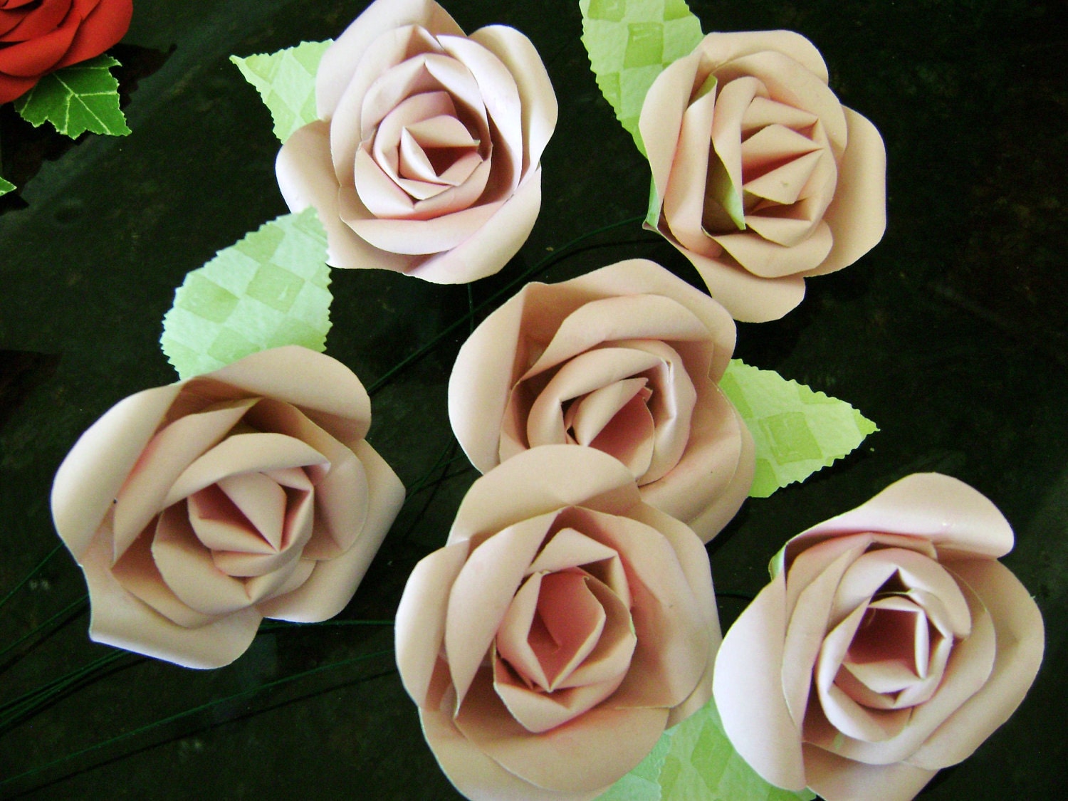Six light pink paper flower long stemmed roses bouquet with green leaves