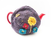Purple Tea Pot Cosy hand knitted in chunky tweed wool with butterfly and colourful crochet flowers