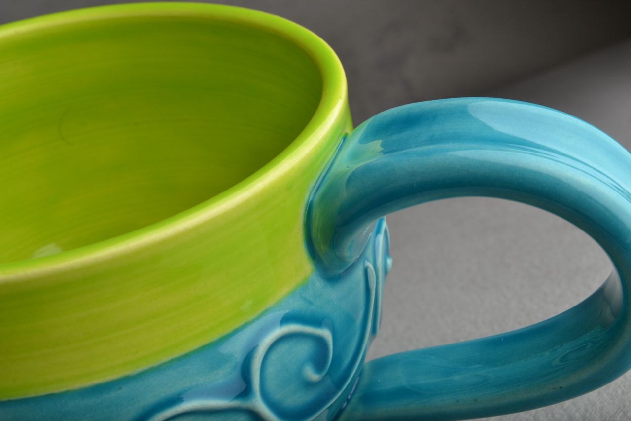 Curly Mug: Caribbean Blue and Neon Green Slip Trailed Mug by Symmetrical Pottery
