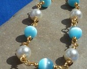 Sale 30% Off Aqua and white wire wrapped beaded bracelet, fiber optic cats eye and faux pearl, gold dipped silver plate jewelry wire