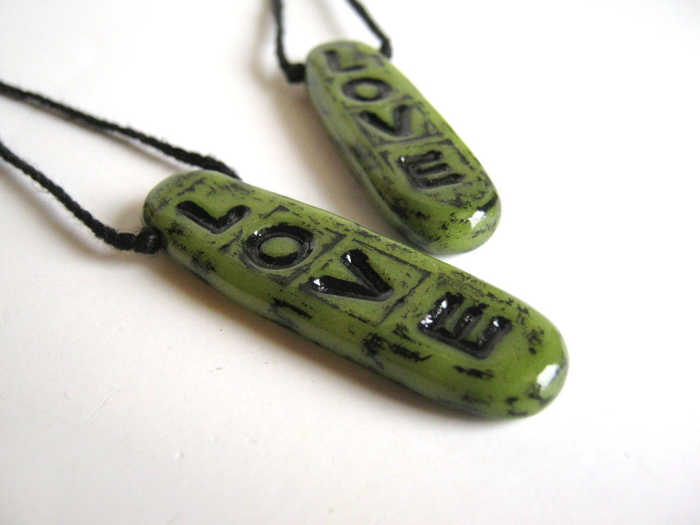 Tropical lime green typographic polymer clay art pendant that spells out L-O-V-E in a distressed urban black finish