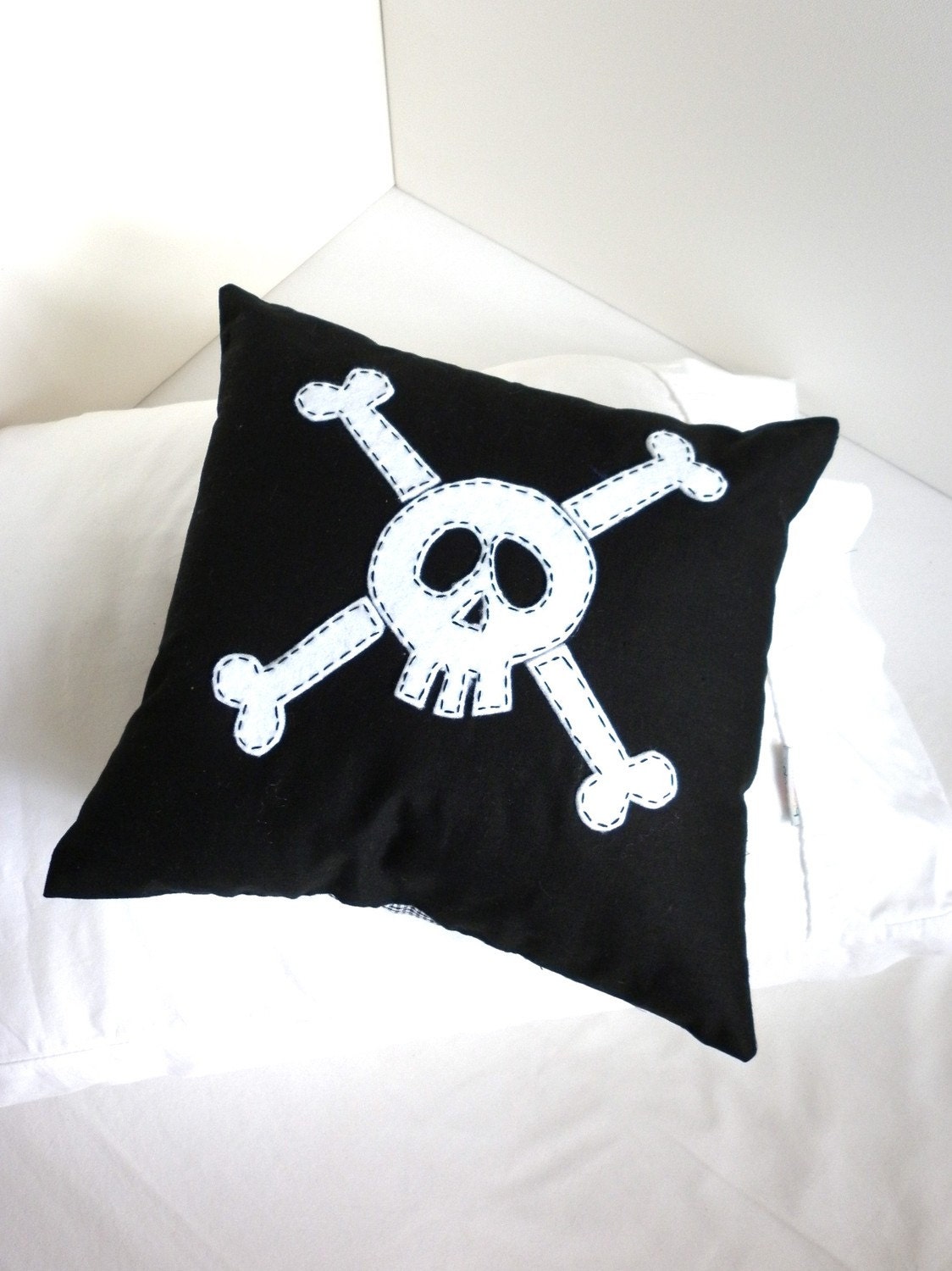 Black Skull and Crossbone cushion cover in small.