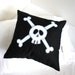 Black Skull and Crossbone cushion cover in small.