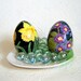 Garden primula on darkly grey background. Duck egg. Easter eggs.