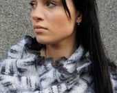 Beautiful hHand knit Shawl of white and gray shades of yarn. Decorated with a gray ruffles around the edges.