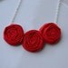 Red triple rosette necklace
