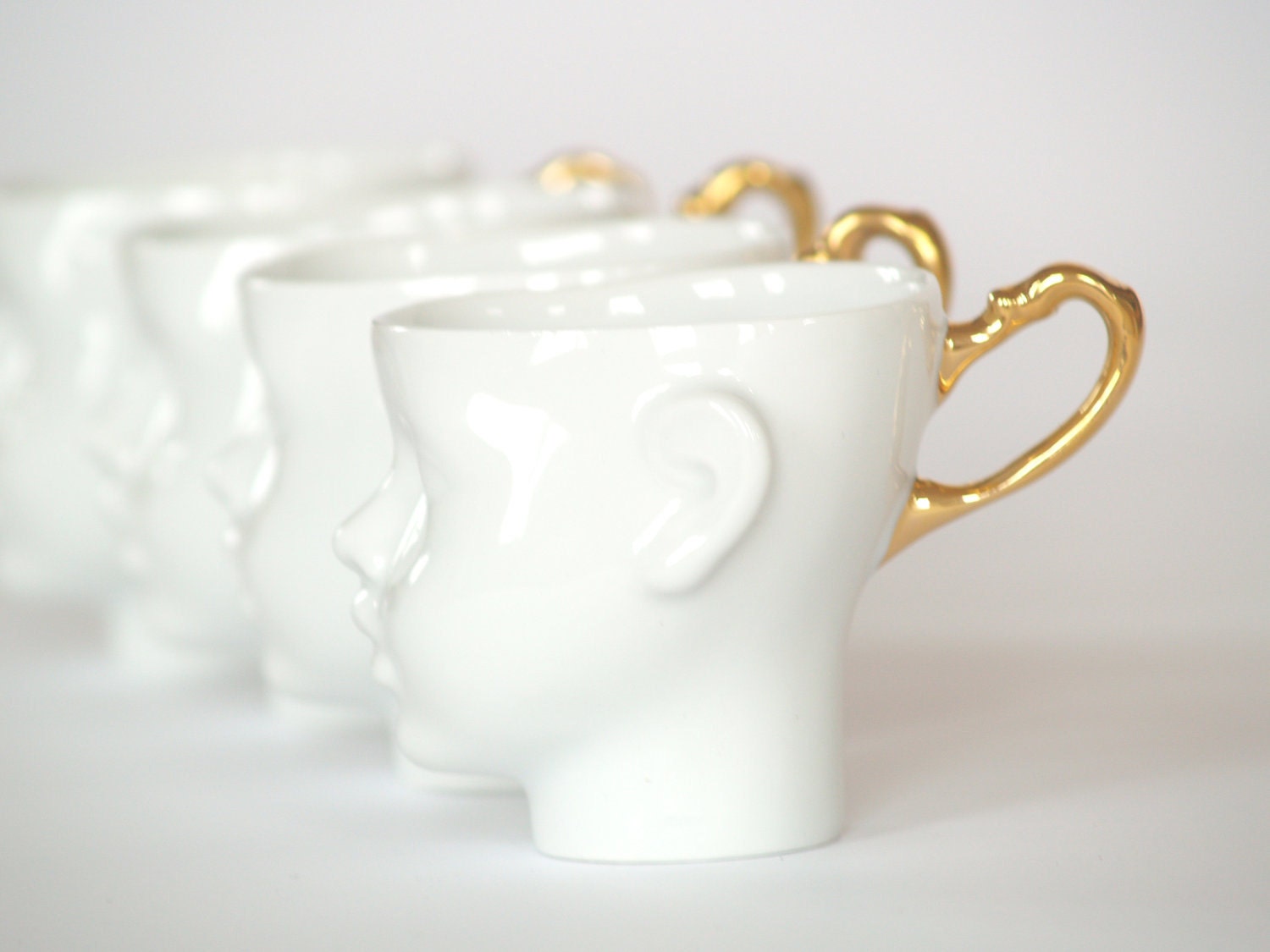 Doll head cups - set of four white porcelain and gold artisan cups,