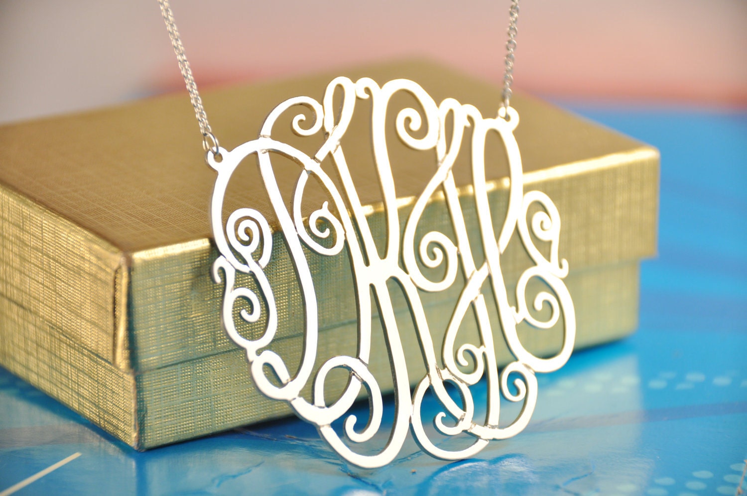 sterling silver   monogram 2" diameter with a silver chain
