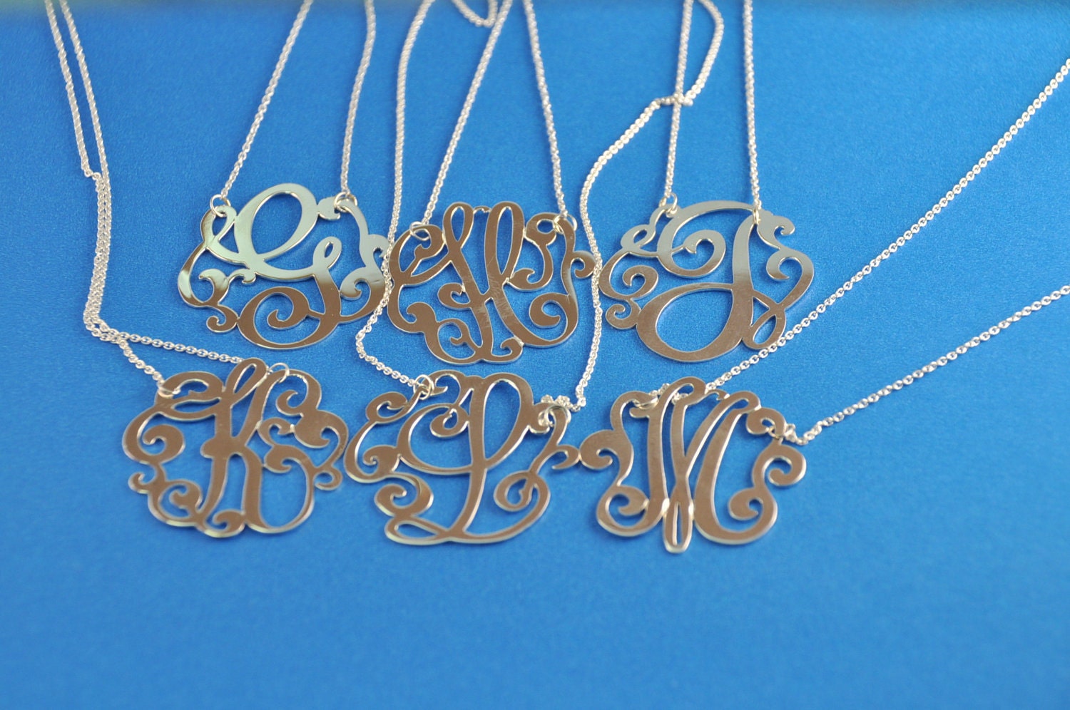 Sterling silver  initial. 1.25" size. with a  chain.