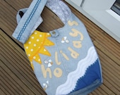 Recycled Blue  denim  handbag with grey and white flower pattern cotton lining, appliqué, shells and bead decoration.