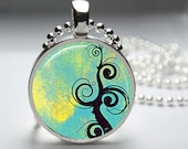1in Circle Glass Bezel Pendant - Beautiful Black Swirling Design over Yellow and Blue Watercolors - Free Ball Chain Necklace - HipsterDesigns