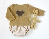 A knitted sweater with diaper cover in camel with a heart