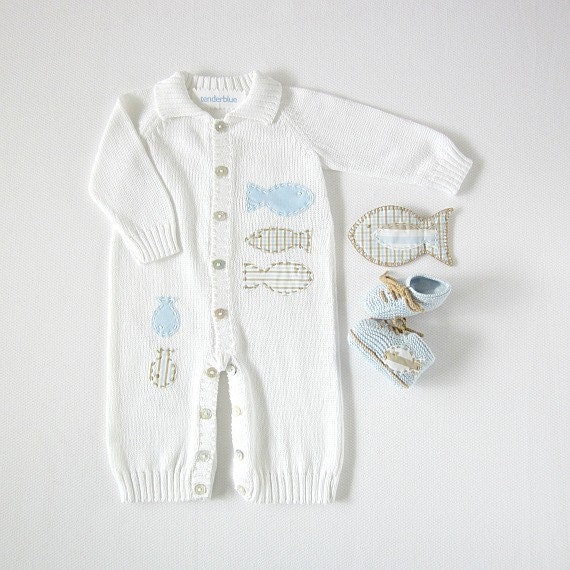 A knitted overalls in white full of fishes. Matching booties. - tenderblue