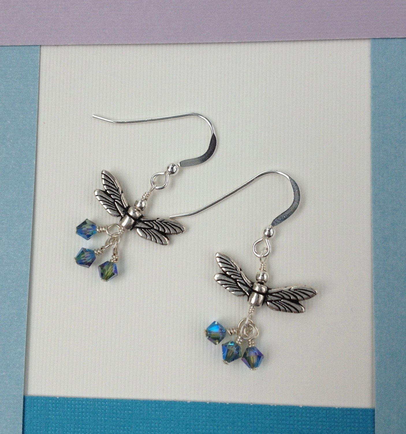 Silver dragonfly earrings with iridescent blue bicone crystals