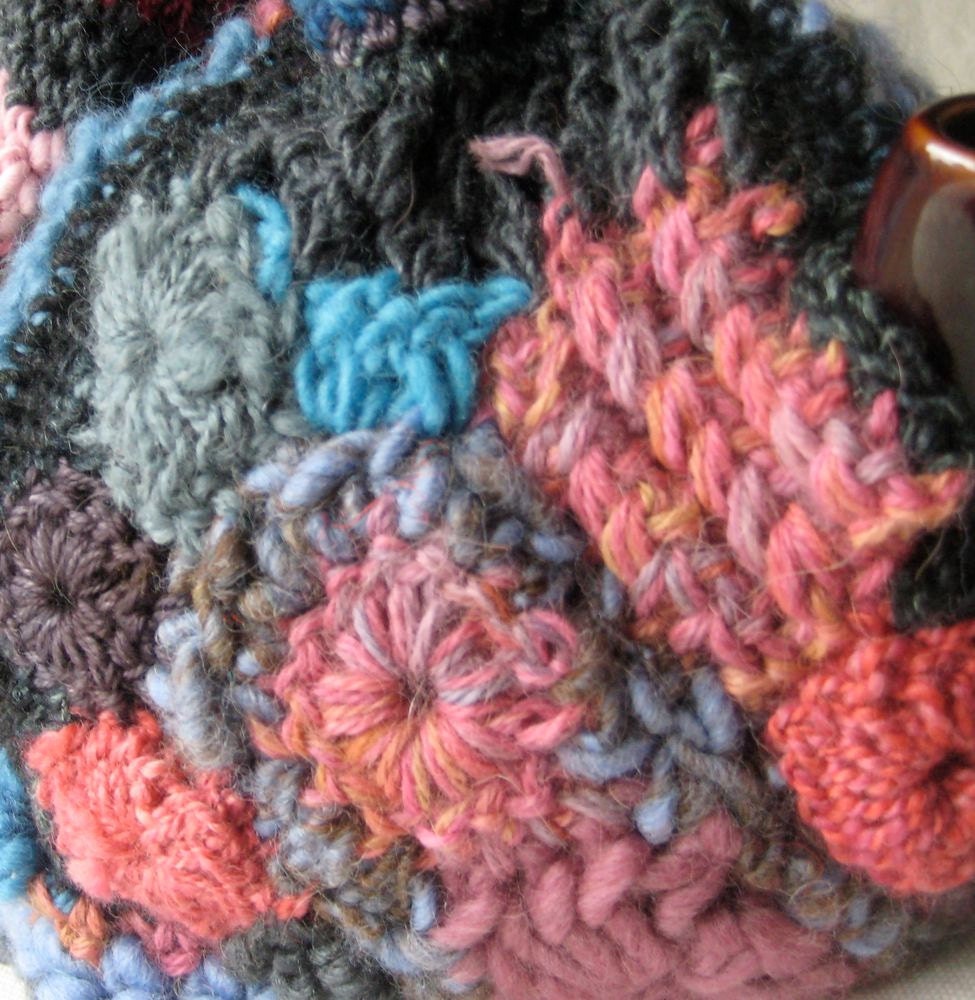 Tea Cozy made in Freeform Crochet and knitting - blue, pink, and charcoal with a hat