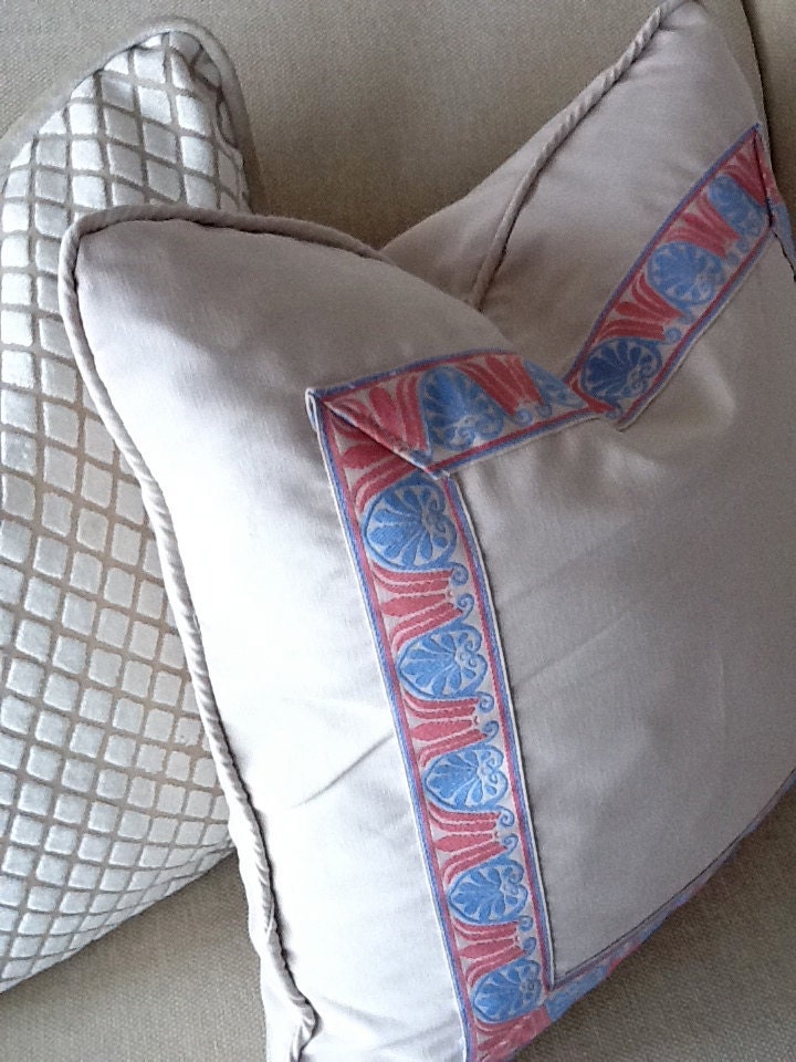 A Pair of Off-white Pillows with Pink and Blue Trim