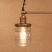 Chandelier Lighting with Twin Glass Shades and Antique Brass Spreader Bar and Black Twisted Wire
