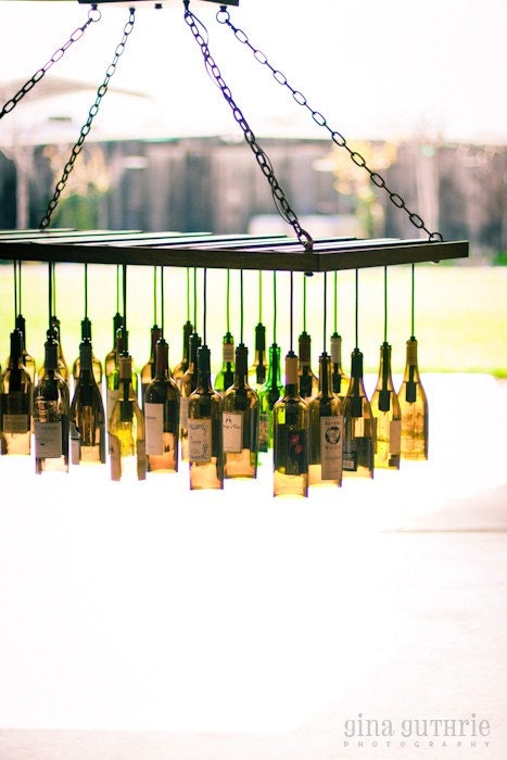 30 Wine Bottle Light Chandelier hanging from wood riddling rack