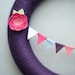 Purple Yarn Wreath. Pink, fuchsia, light blue and white felt flowers and felt bunting. Great for girl's birthday party. 14" door wreath.
