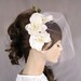 Bridal Fascinator with Birdcage Veil, Orchid Flower Decorated Head Piece for Beach Weddings. Handmade. unique design