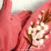 Pink fingerless gloves with felted flower.