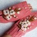 Pink fingerless gloves with felted flower.