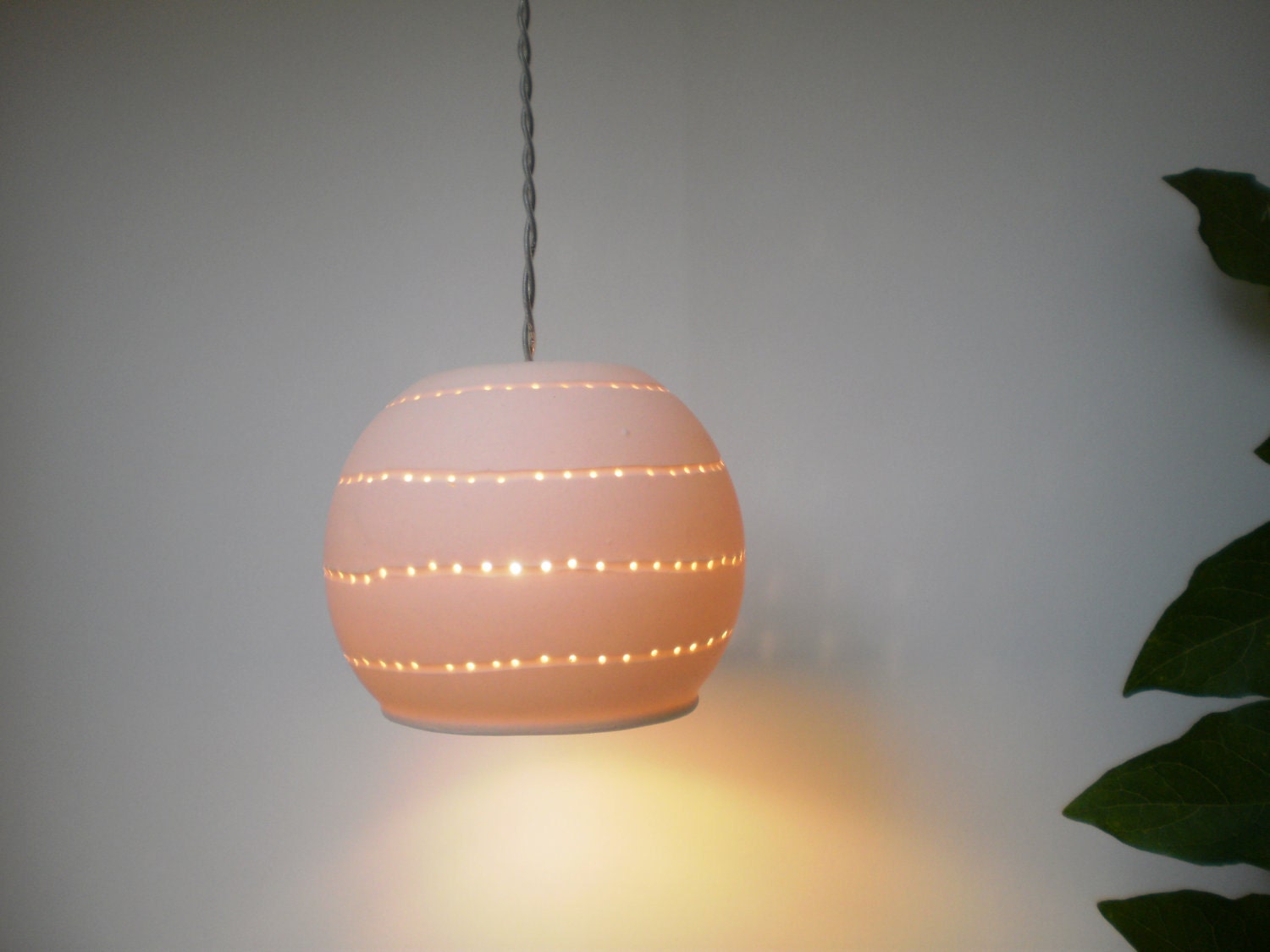 Small porcelain ball with spiral holes.