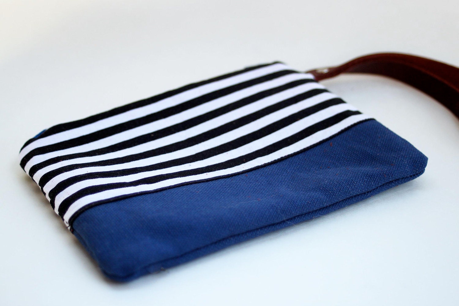 wristlet clutch in black and white stripe and blue