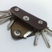 Extremely convenient keychain key holder from dark brown cowhide. Holds 6-8 regular keys, free monogramming , personalized/ belt hanger