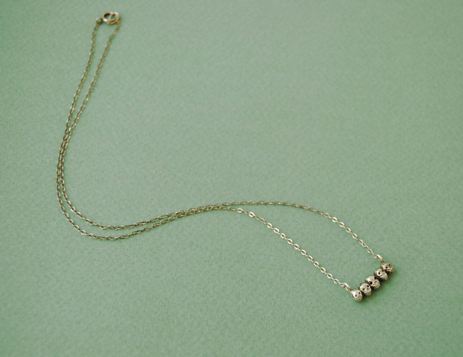 Tiny sterling silver skull necklace