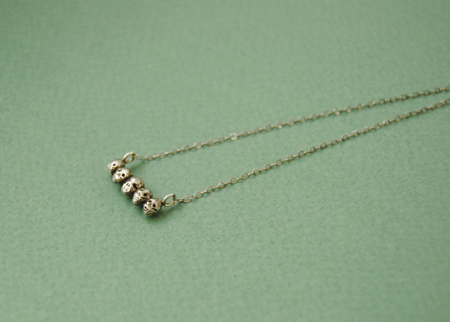 Tiny sterling silver skull necklace