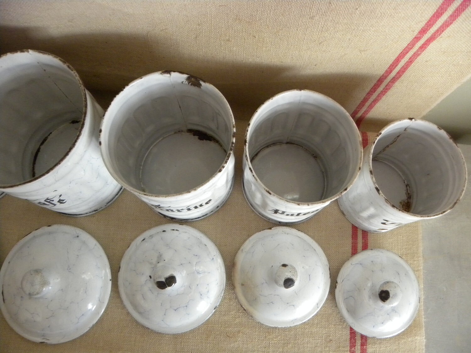 A serie of french white vintage enamel kitchen canisters. Cheaper shipping price in two parcels