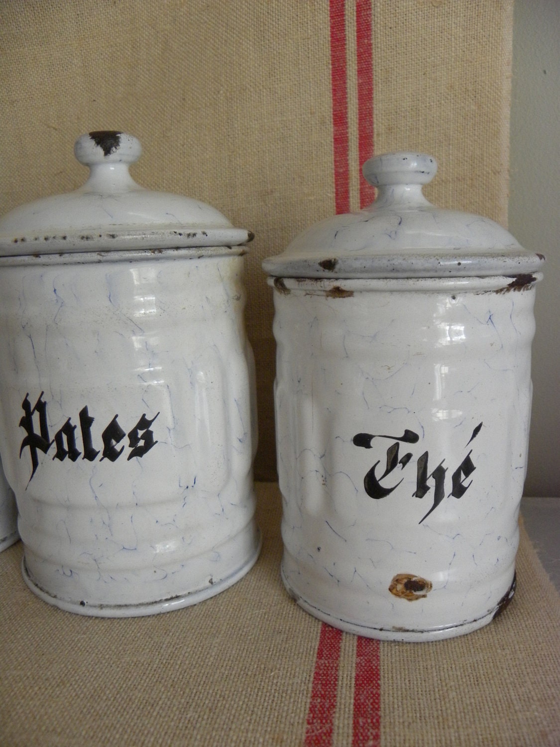 A serie of french white vintage enamel kitchen canisters. Cheaper shipping price in two parcels