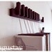 Custom made wooden book rack / bookshelf in Wenge. Pins also work as bookmarks. Bookcase