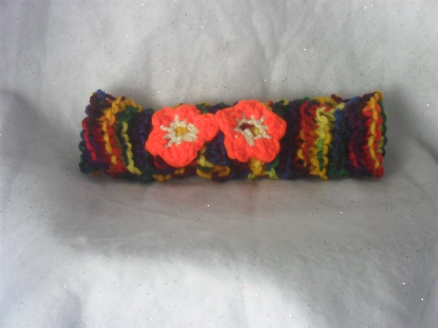 Lovely Multi Colored Knitted Headband with a 2 Orange Crocheted flowers.