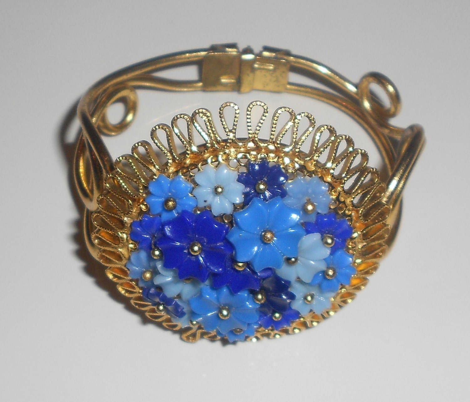 Vintage floral cuff hinged bracelet with celluloid blue flowers