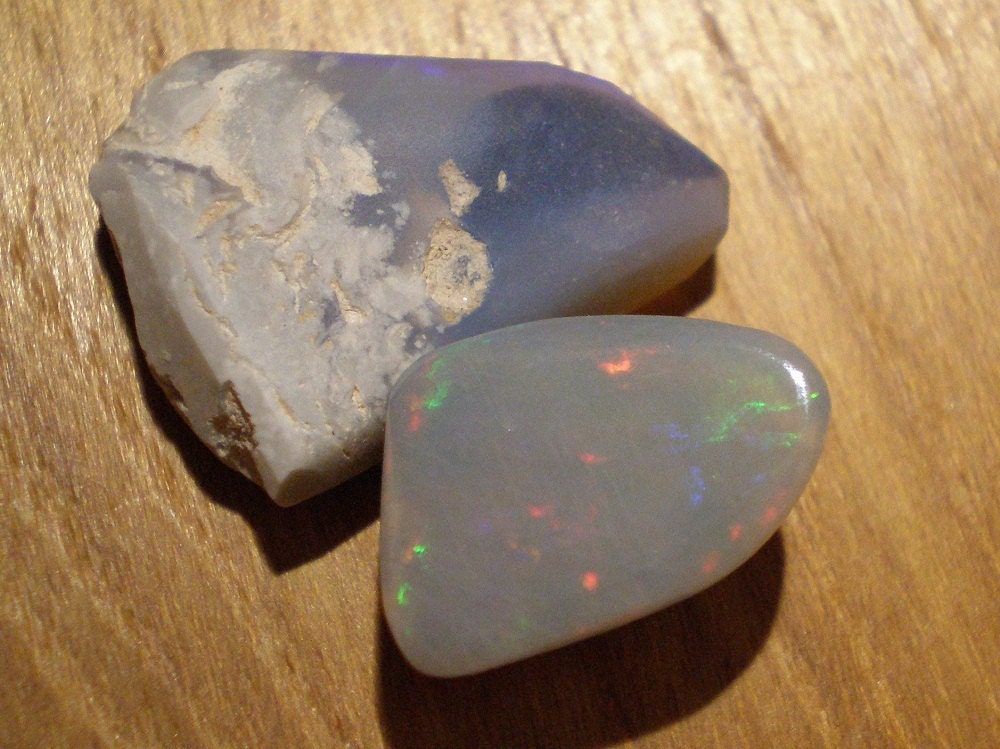 opal cabochon from Lighting Ridge Australia shown next to rough as contrast Ready to Ship