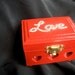 Mini jewelry box with 3 carved hearts in the front embellished with rhinestones and fully lined with felt