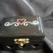 Mini jewelry box in black with 3 carved hearts in the front embellished with rhinestones and fully lined with felt