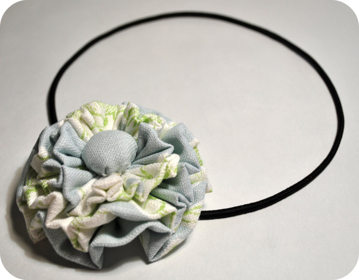 Ruffle corsage headband:Abstract floral design in blue,green and white.